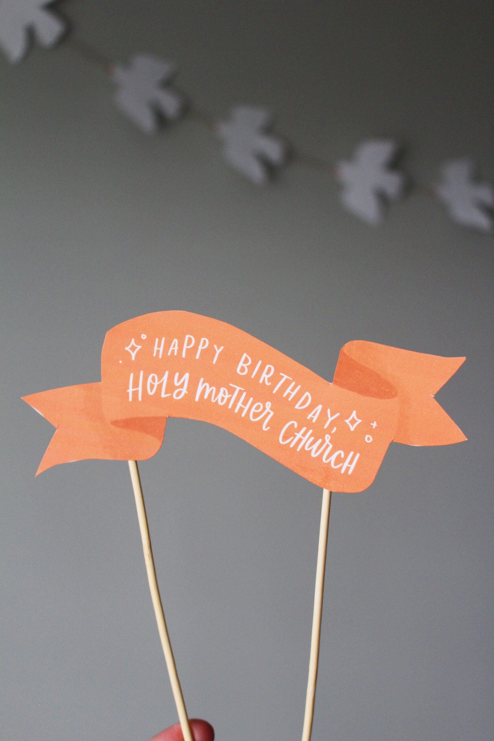 printed illustration of a banner that reads happy birthday to holy mother church