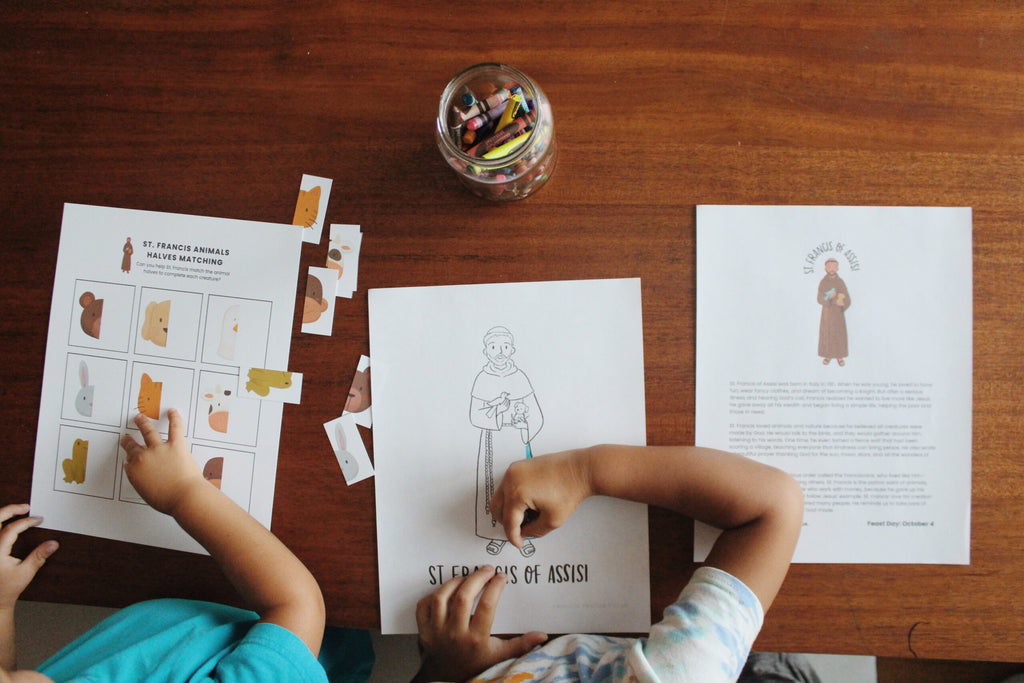 Two children engaged in educational activities on a wooden table with printed materials and a jar of pencils.